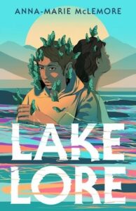 The book cover has two teens who appear to be standing chest deep in a lake one looking away and one facing the viewer. There are mountains and the sun visible behind them. The lake has a variety of colors - blue, green, red, orange, purple in swirls. The teens have brown skin and brown hair and thee are green butterflies on their heads. One is wearing a white shirt and the other a yellow hoodie. 