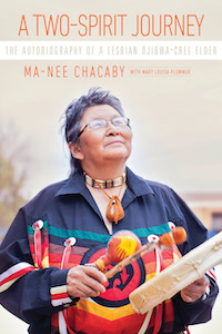 The author Ma-Nee is shown on the front cover dressed in native style holding a drum in her hands. She is looking up off in the distance. Her shirt is blue with stripes of green and red on her chest. There are ribbons attached to the stripes. She is wearing a beaded necklace that circles her neck multiple times.